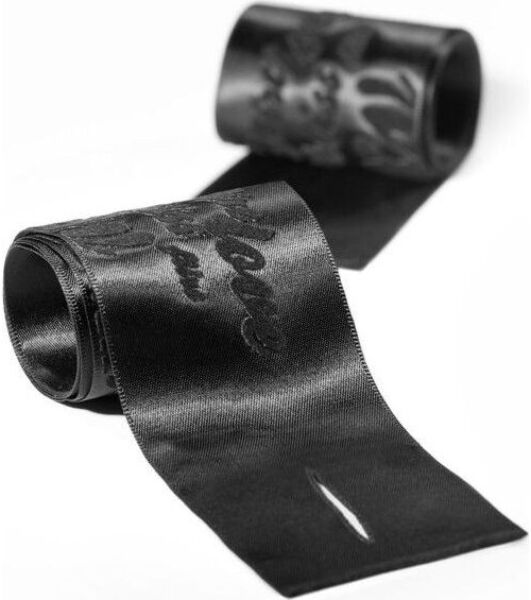 The two satin ribbons of the Bijoux Indiscrets Silky Sensual Handcuffs, with their velvety print